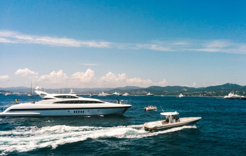 white and blue boat on sea under blue sky during daytime