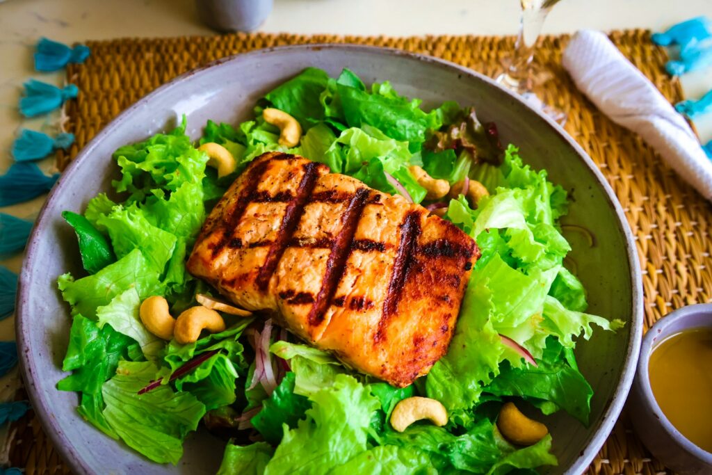 Grilled salmon salad with cashews.