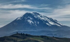a large snow covered mountain in the distance