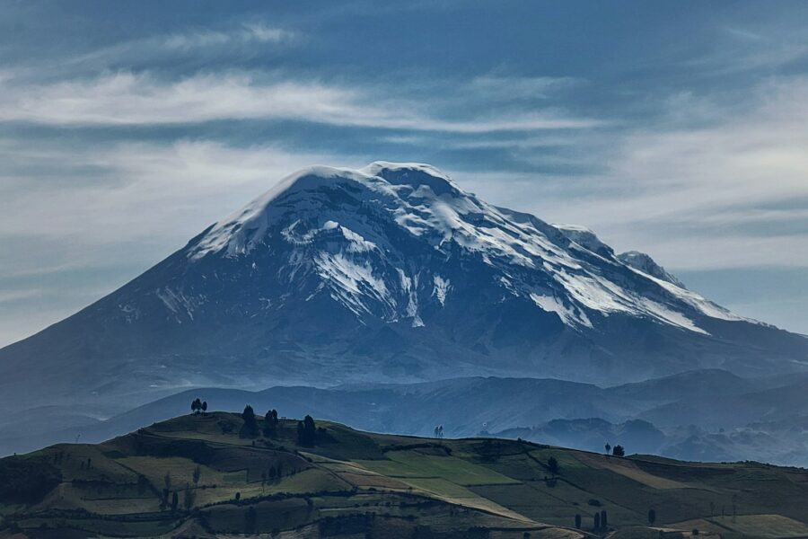 a large snow covered mountain in the distance