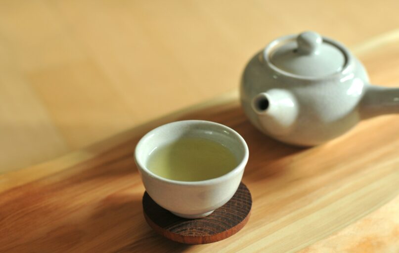 white ceramic teacup on brown wooden table