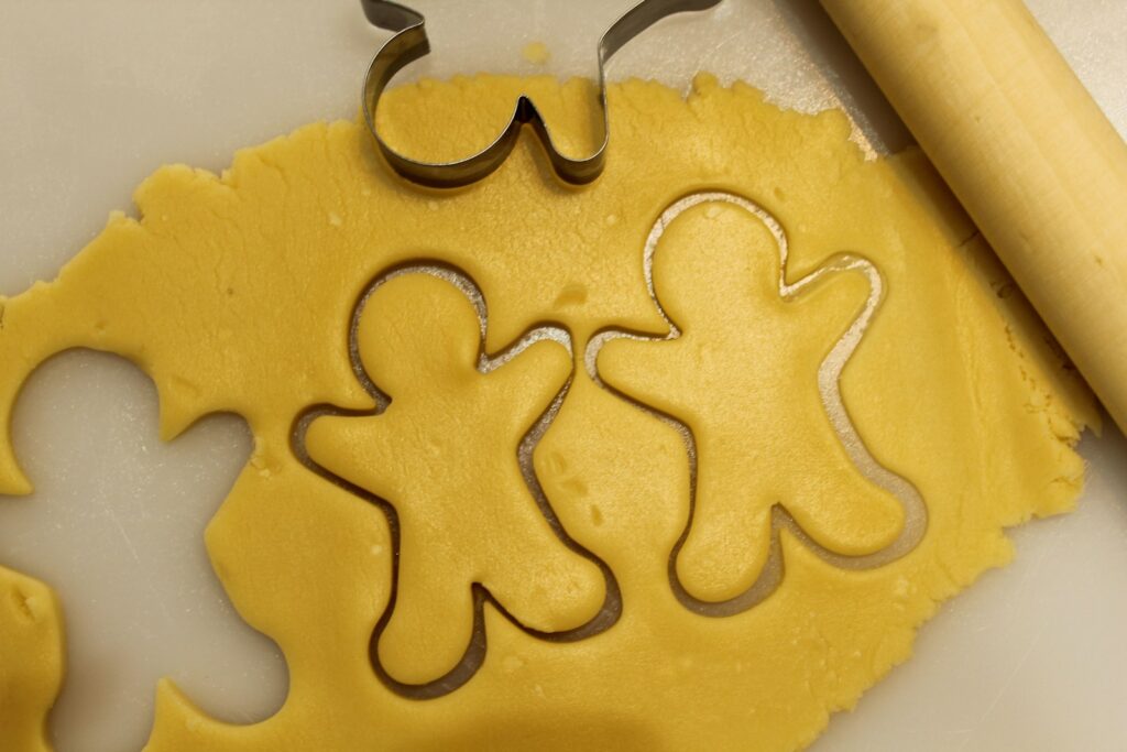 a cookie cutter next to some cut out cookies