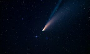 a comet is seen in the night sky
