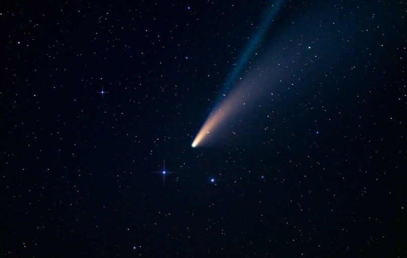a comet is seen in the night sky