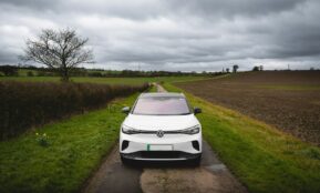 White electric car parked on a rural road