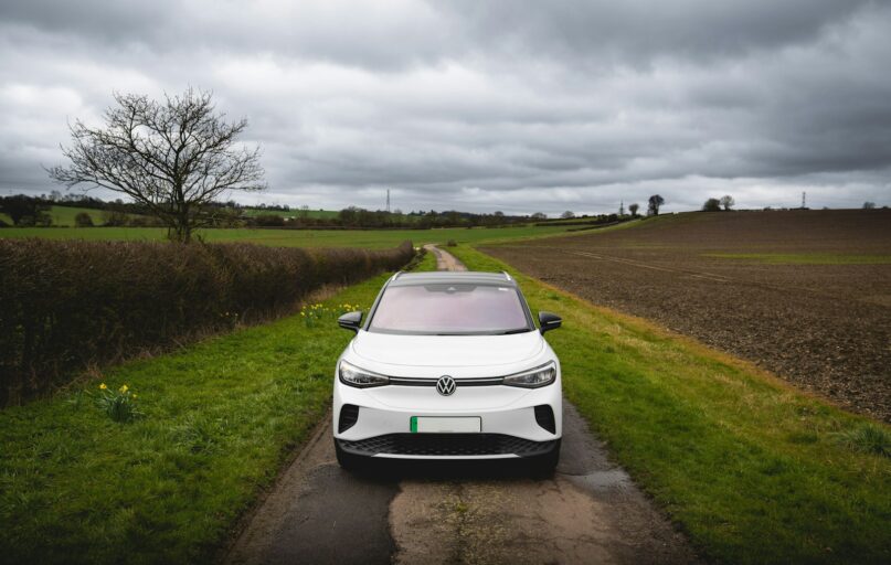 White electric car parked on a rural road