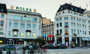 City street with rolex sign and buildings