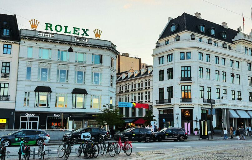 City street with rolex sign and buildings