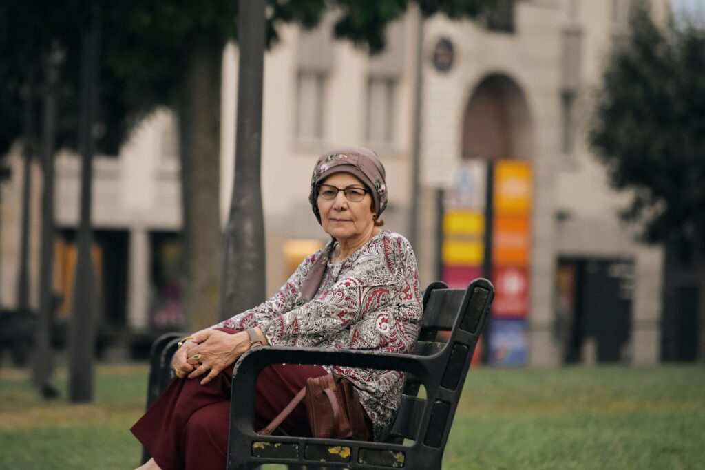 A woman sitting on a bench in a park