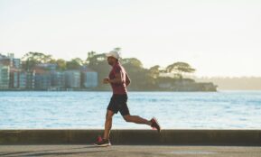 man running near sea during daytime