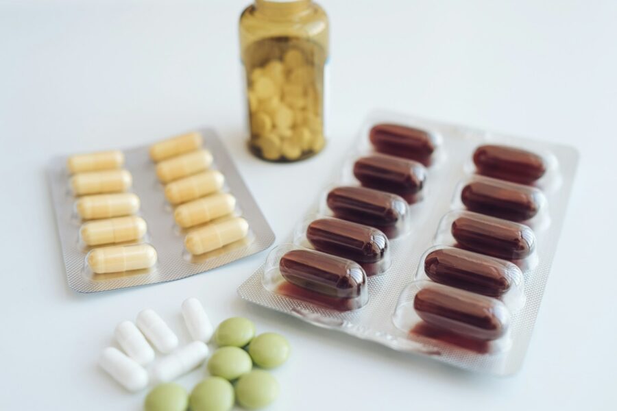 a table topped with pills and a bottle of pills
