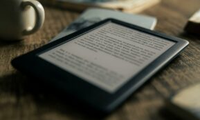black tablet computer on brown wooden table