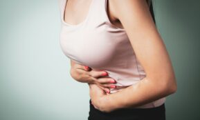 A person holding their stomach in pain.