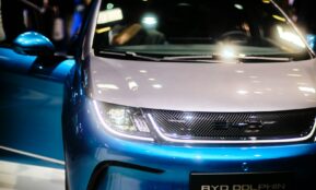 a close up of the front of a blue and white car