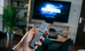 person holding gray remote control
