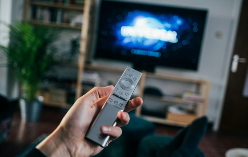 person holding gray remote control