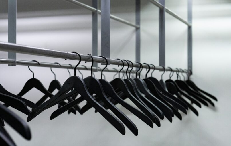 clothes hanged on gray metal wire