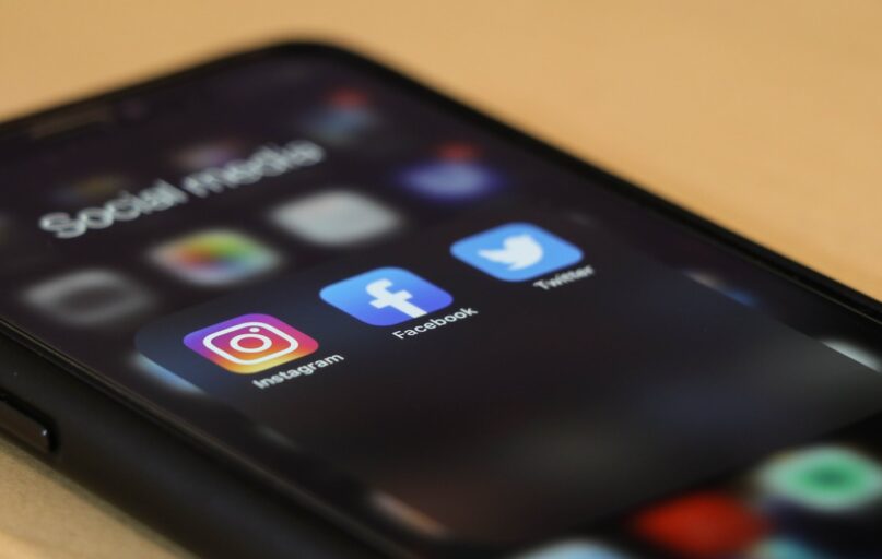 black iphone 4 on brown wooden table