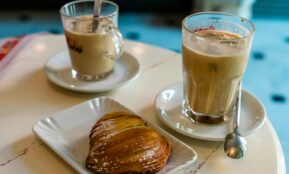 clear glass mug with brown liquid on white ceramic saucer