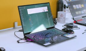 a laptop computer sitting on top of a white desk