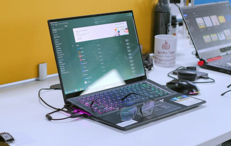 a laptop computer sitting on top of a white desk