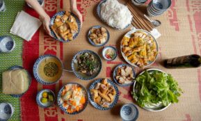 a table topped with bowls of food and plates of food