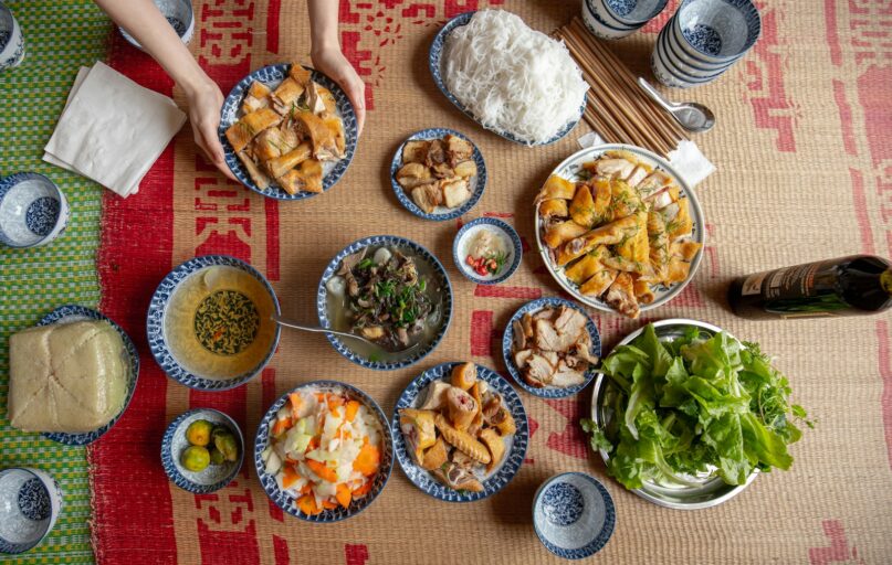 a table topped with bowls of food and plates of food