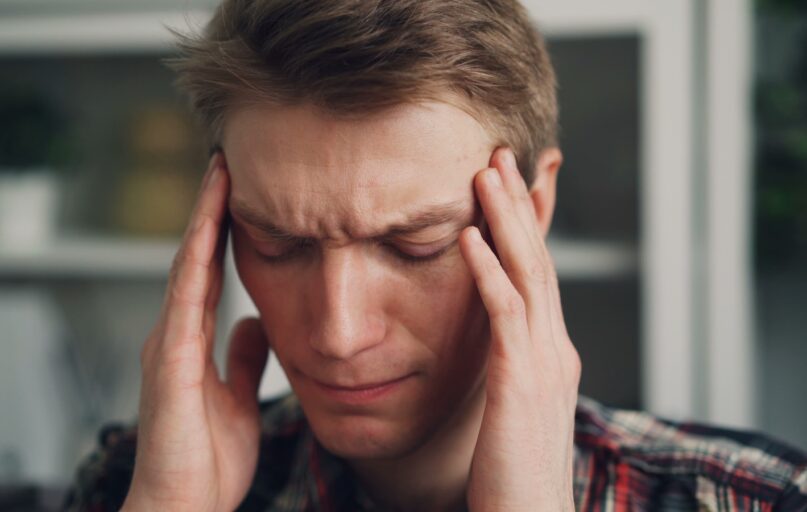 a man holding his hands to his ears