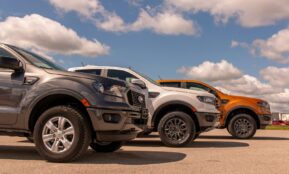 white and black suv on gray asphalt road under blue and white sunny cloudy sky during