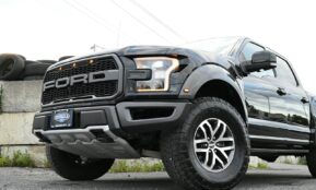 a large black truck parked in a parking lot