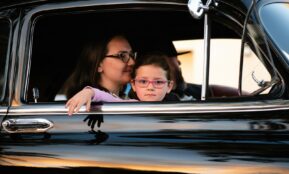 girl and woman inside black car