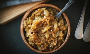 a bowl of food with a spoon next to it