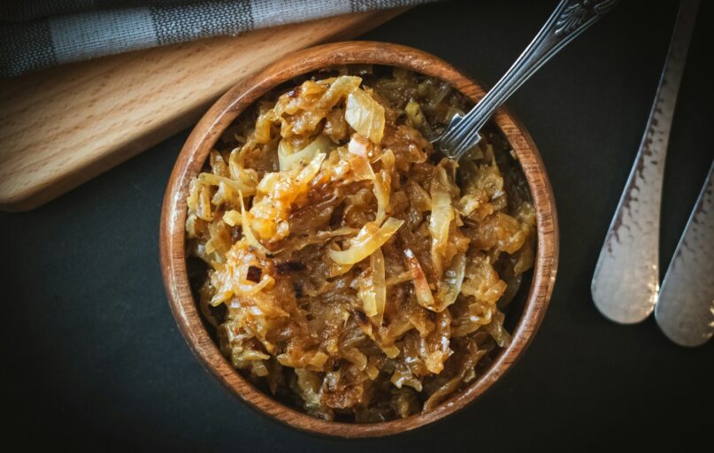 a bowl of food with a spoon next to it