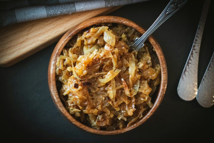 a bowl of food with a spoon next to it