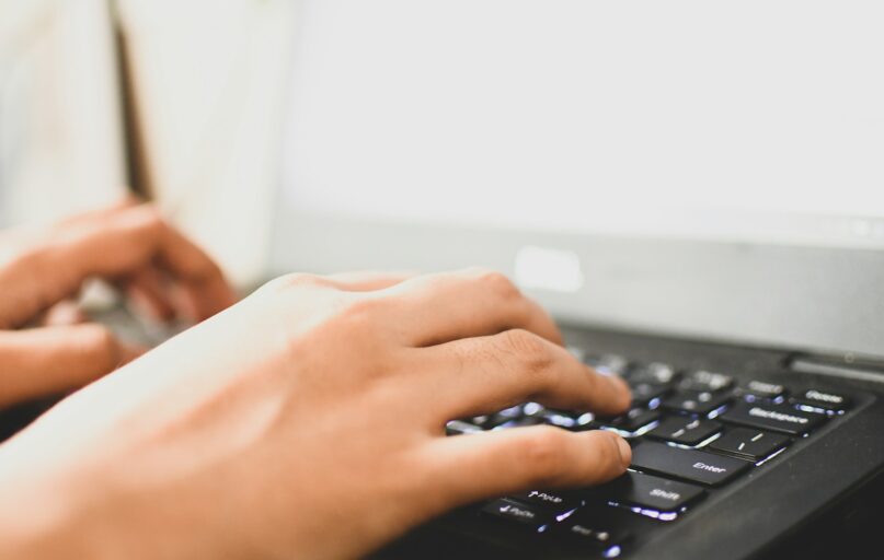 person using black computer keyboard