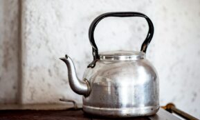 stainless steel kettle on brown wooden table
