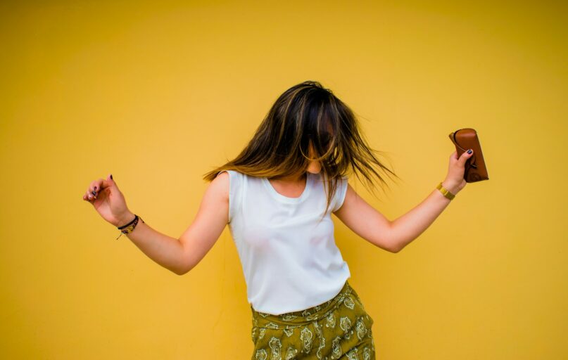 woman standing near yellow wall