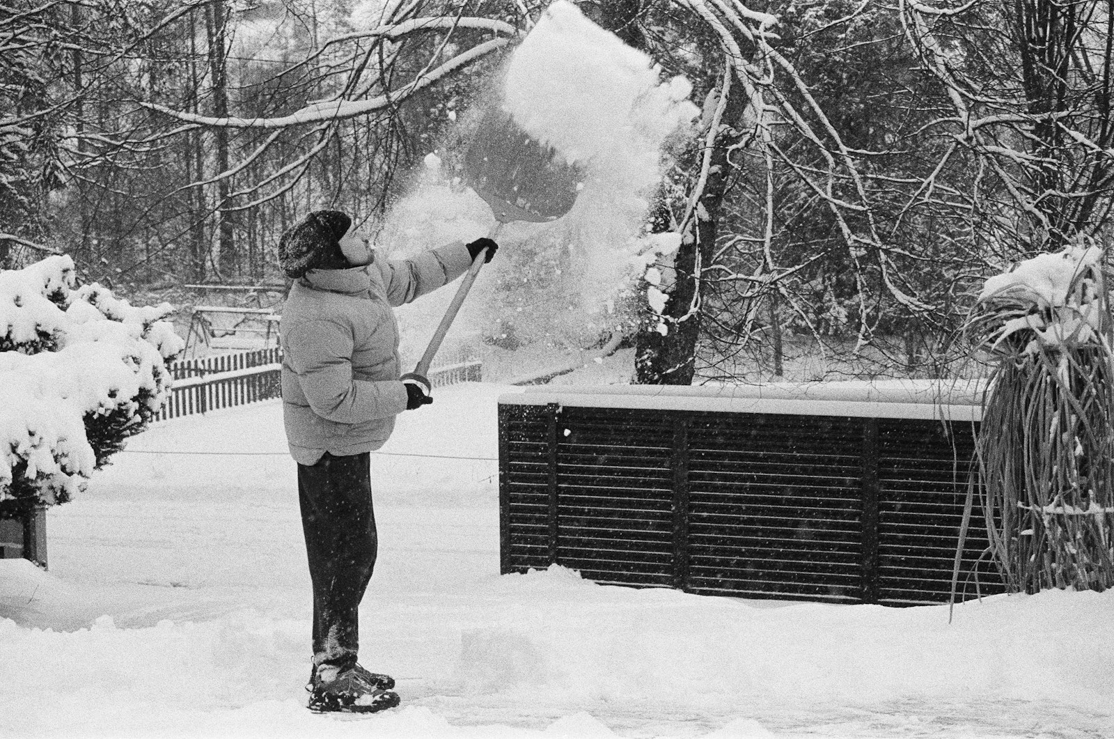 Person shoveling snow in a winter landscape