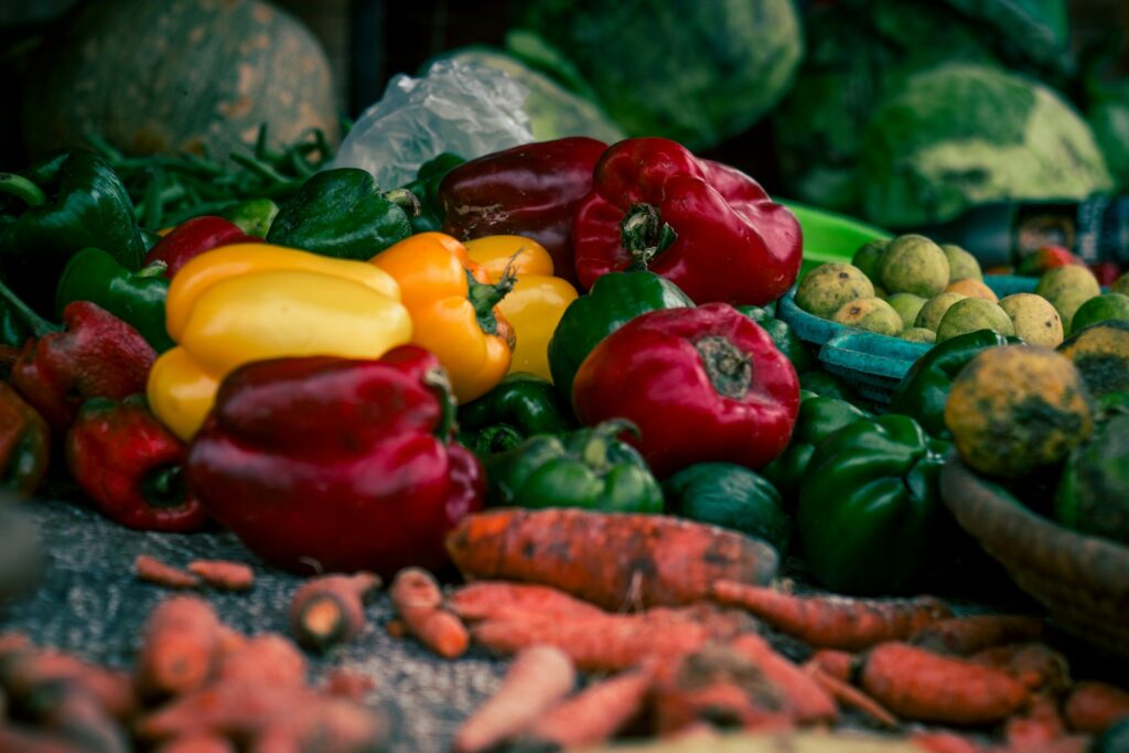 Colorful bell peppers and carrots at a market