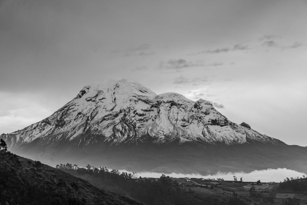 A black and white photo of a snow covered mountain