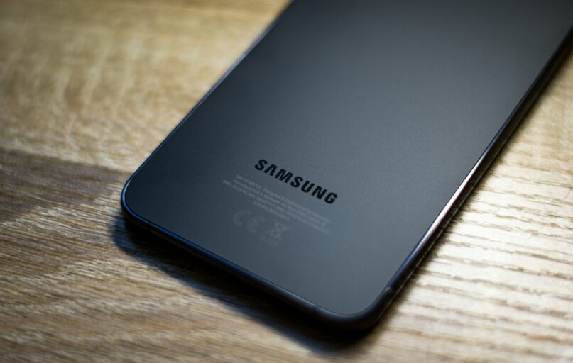 a close up of a samsung phone on a wooden table