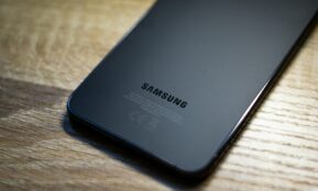 a close up of a samsung phone on a wooden table