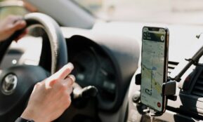 a person using a cell phone while driving a car