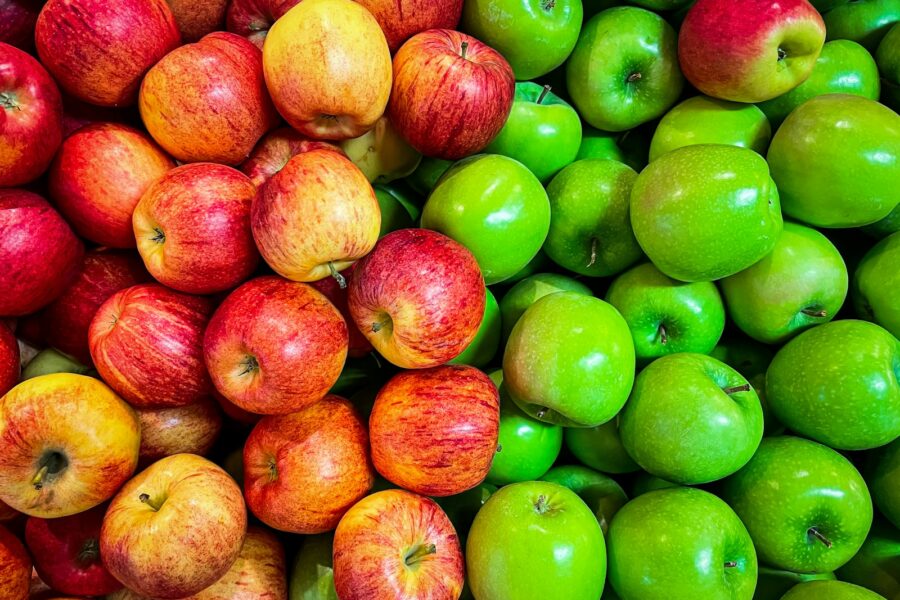 green and red apples on white plastic container