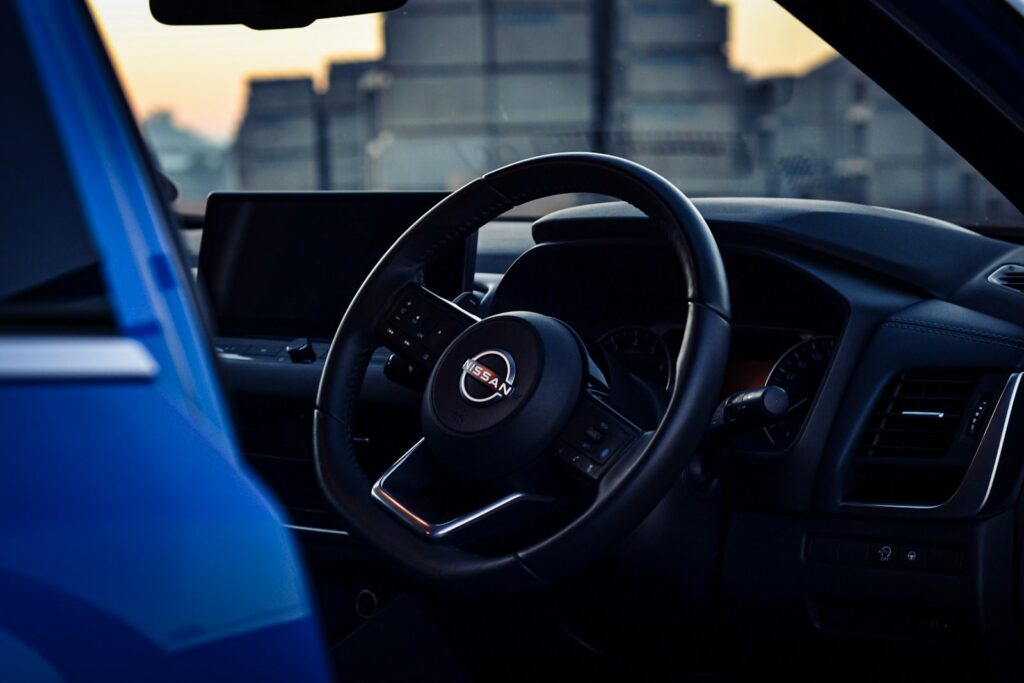 the interior of a car with a steering wheel and dashboard