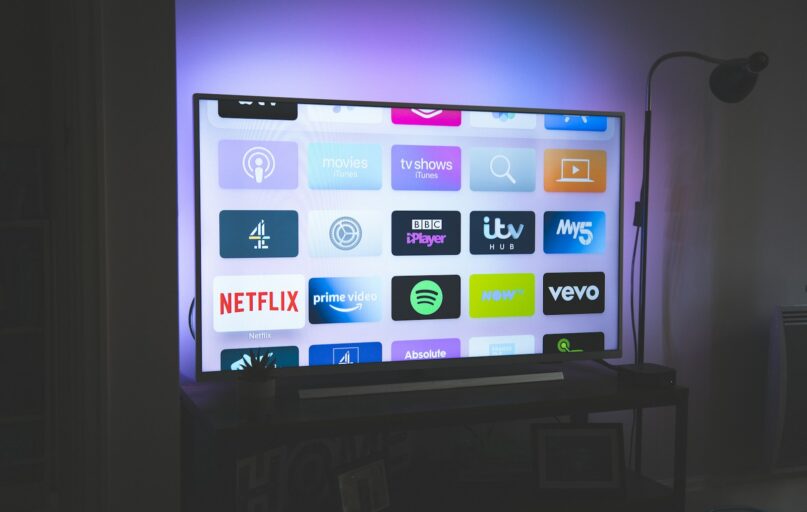 black flat screen tv turned on showing game