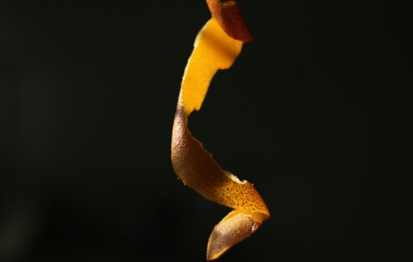 Orange peel spiral against dark background