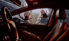 man in white long sleeve shirt driving car