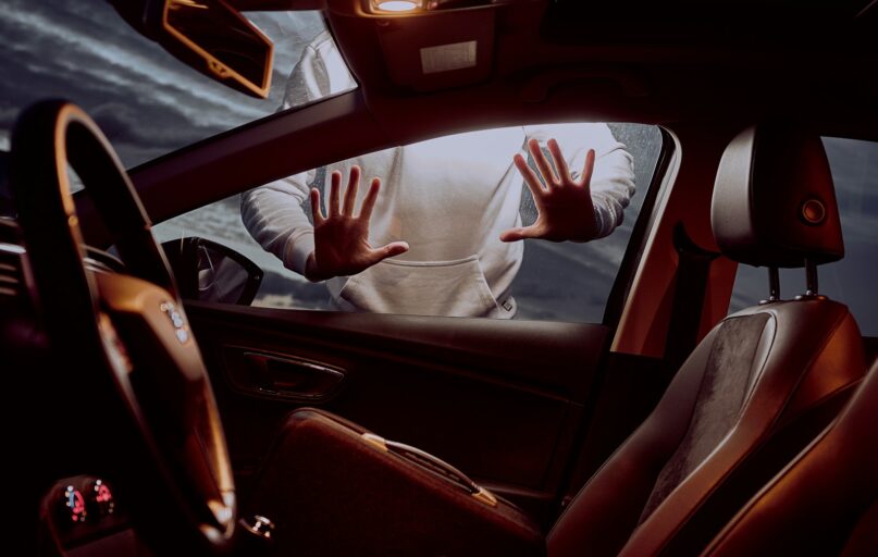 man in white long sleeve shirt driving car