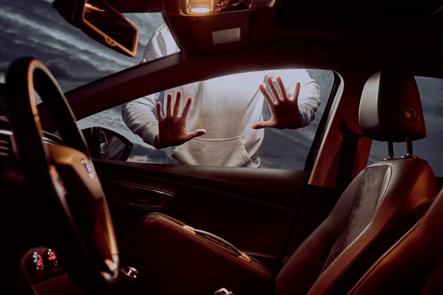 man in white long sleeve shirt driving car
